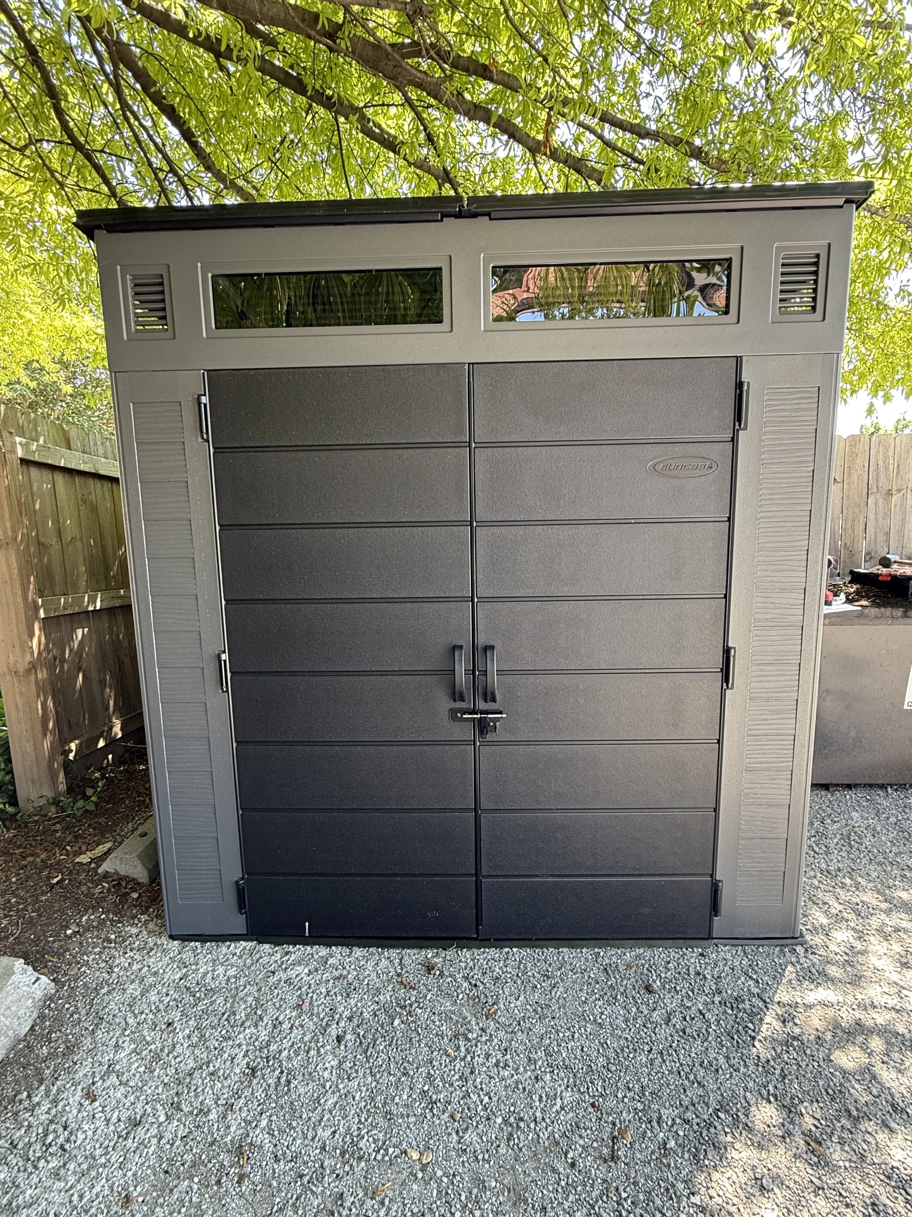 Completed gray storage shed outside the restaurant service area